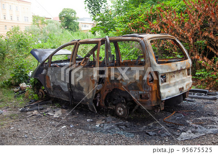 Car after a fire. Burnt rusty car after fire or accident. Car after the fire, crime of vandalism Car after a fire. Burnt rusty car after fire or accident. Car after the fire, crime of vandalism 95675525