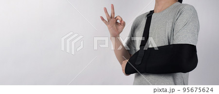 Broken arm. Arm Sling therapy support and covered around elbow first knuckle broken arm. Post Operative Care. Fractures of humerus radius ulna scapula. Arm Sling after accident. Isolated background. Broken arm. Arm Sling therapy support and covered around elbow first knuckle broken arm. Post Operative Care. Fractures of humerus radius ulna scapula. Arm Sling after accident. Isolated background. 95675624