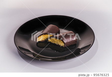 A piece of chocolate cake with mint on the table, close-up 95676325