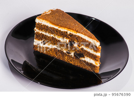 carrot cake with walnuts, prunes and dried apricots on a dark wood background. tinting. selective focus carrot cake with walnuts, prunes and dried apricots on a dark wood background. tinting. selective focus 95676390