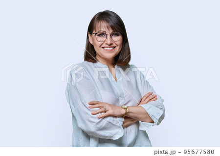 Positive middle aged woman looking at camera on white studio background 95677580