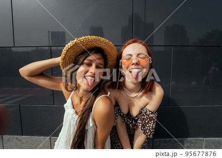 Two attractive young women fooling around in fresh air. 95677876