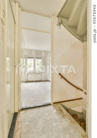 Perspective view of empty narrow hallway with white walls and parquet floor in minimalist style apartment Perspective view of empty narrow hallway with white walls and parquet floor in minimalist style apartment 95678948