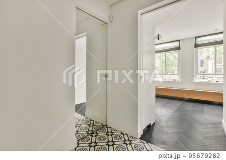Light hallway with glass door in white walls 95679282