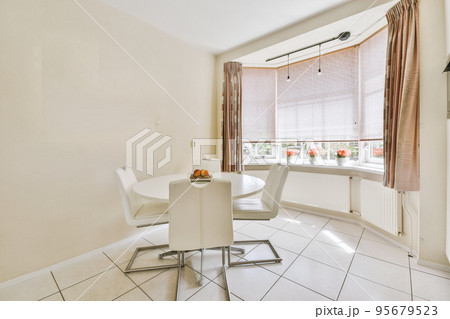 Interior of light kitchen and dining room with at daytime 95679523