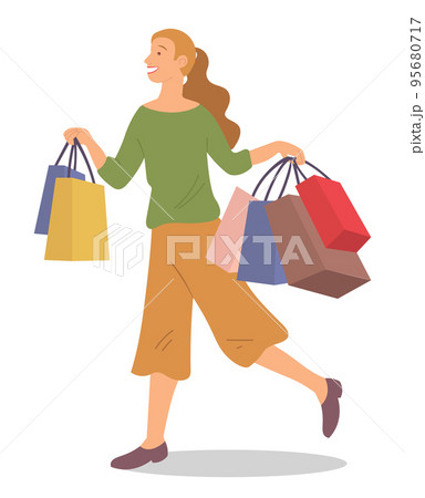 Smiling woman is standing with shopping bags. Young fashion girl picks up packages with clothes 95680717