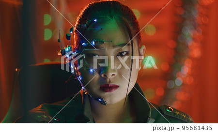 Cyberpunk girl looks at the computer screen futuristic one-eyed glasses with mic 95681435