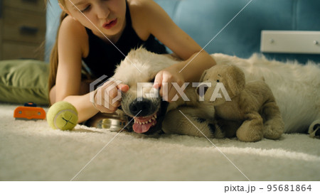 Young girl playing with dog 95681864