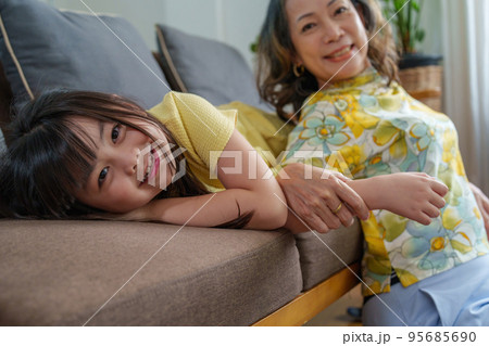 Asian portrait, grandma and granddaughter doing leisure activities and hugging to show their love and care for each other. 95685690