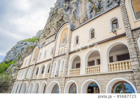 Monastery of Ostrog, Serbian Orthodox Church situated against a vertical background, high up in the large rock of Ostroska Greda, Montenegro. Dedicated to Saint Basil of Ostrog 95687725