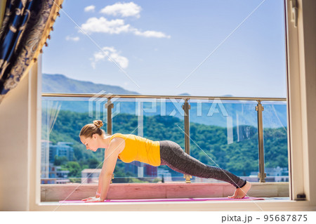 Beautiful woman doing yoga outdoors on a rooftop terrace 95687875