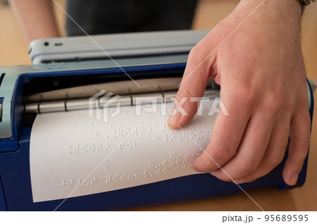 Blind man using braille typewriter. Blind man using braille typewriter. 95689595