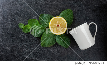 White mug, lemon, and mint. 95689721