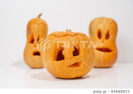Three jack-o-lantern on a white background. Halloween decoration. 95689855