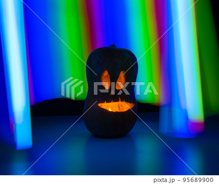 Jack-o-lantern glow in the dark against the backdrop of a rainbow. Halloween decoration. 95689900