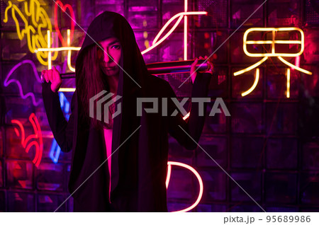 Male transgender neon light studio. Asian with samurai sword. 95689986