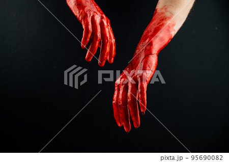 Women's hands in blood on a black background. Women's hands in blood on a black background. 95690082