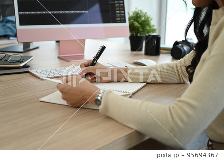 Cropped shot of female video editor working with footage and sound in creative office studio 95694367
