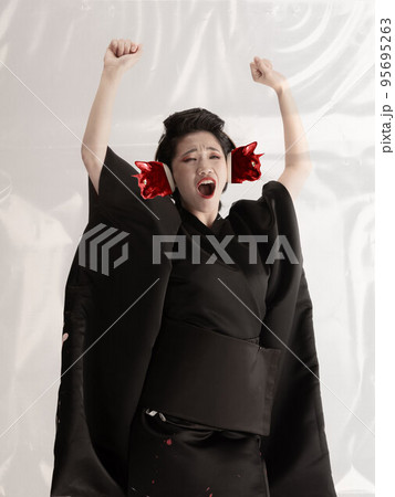 Contemporary art collage. Creative design. Young woman, geisha in black kimono with cat's muzzles on head over white background 95695263