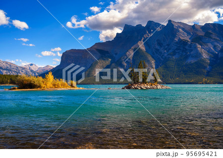 Small island with trees on Lake Minnewanka in Banff National Park, Canada 95695421
