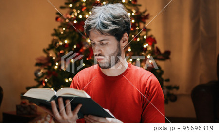Reading Book Under Christmas Tree in the house 95696319