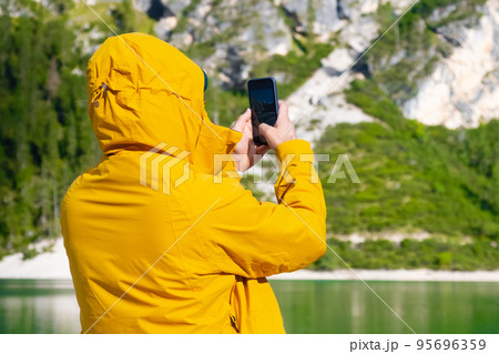 Travel blogger and tourist taking photo by smartphone of amazing landscape. Travel blogger and tourist taking photo by smartphone of amazing landscape. 95696359