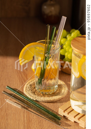 Glass of water with fresh lemon juice with Reusable glass Straws Detox cold tonic water with sunny lemon slices Low-waste lifestyle Eco-Friendly Drinking Straw Glass of water with fresh lemon juice with Reusable glass Straws Detox cold tonic water with sunny lemon slices Low-waste lifestyle Eco-Friendly Drinking Straw 95697602