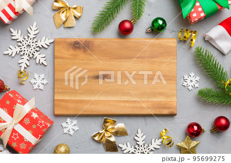Festive table decoration with New Year branches and dekor an empty plate. Top view with space for text. Christmas time Festive table decoration with New Year branches and dekor an empty plate. Top view with space for text. Christmas time 95699275