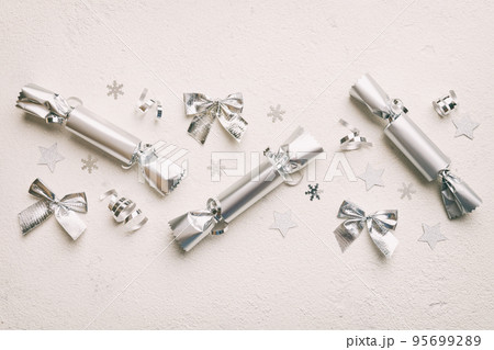 Christmas crackers with shiny confetti on color background, top view, copy space Christmas crackers with shiny confetti on color background, top view, copy space 95699289