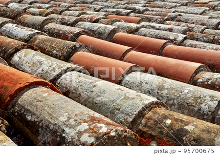 weathered tiles on old roof close up background weathered tiles on old roof close up background 95700675