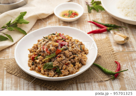 Stir Fried Minced Pork with Basil leave on white plate Stir Fried Minced Pork with Basil leave on white plate 95701325