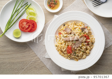 Pork Fried Rice with egg and tomato in white plate.asian food.Top view 95701367