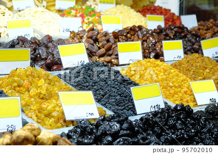Vegetarian healthy food concept. Different kinds of raisins and other oriental sweets are sold at market. Raisins close up. 95702010