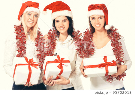 group of female students in costume of Santa Claus with Christmas gifts . 95702013