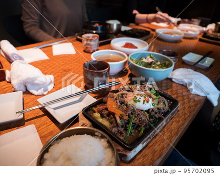 A Korean main course with beef and egg topping rice 95702095