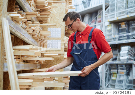 sales consultant standing near the laminate rack. sales consultant standing near the laminate rack. 95704195