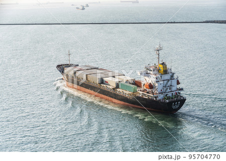 The container ship is leaving the Port of Kaohsiung, Taiwan. 95704770