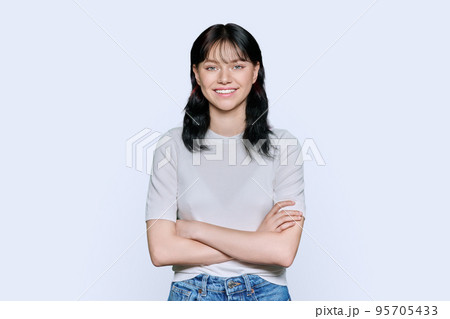 Portrait of positive young female with arms crossed over white background 95705433