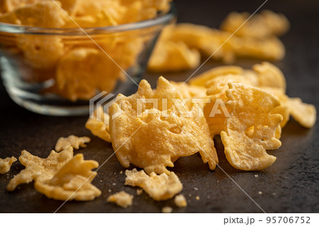 Halloween crispy bat shaped chips on dark table. Halloween crispy bat shaped chips on dark table. 95706752