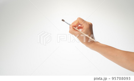 Hand and brush for drawing on a white background, draws a right-hander Hand and brush for drawing on a white background, draws a right-hander 95708093