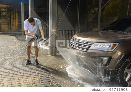 He loves his car. Man washing car. He loves his car. Man washing car. 95711908