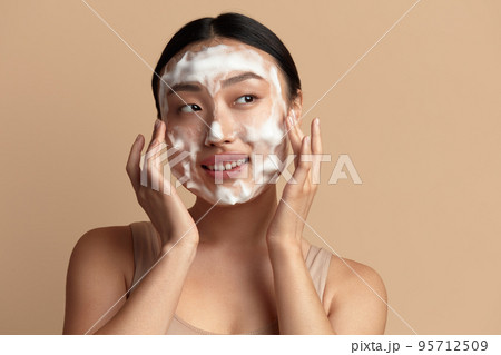 Face Skin Care. Cute Asian Woman Cleaning Facial Skin with Foam Soap Face Skin Care. Cute Asian Woman Cleaning Facial Skin with Foam Soap 95712509
