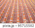 Vintage rooftop tile pattern, a close up of traditional ancient colorful tiles for background wallpaper. 95715502