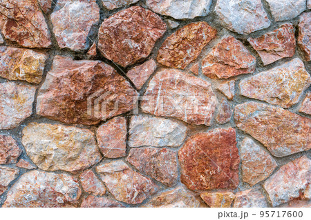 Pink marble stone wall texture background. Closeup surface grunge limestone texture, stonework rock, old pattern clean grid uneven bricks design stack. 95717600