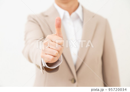 親指を立ててサムズアップをするスーツ姿のミドル女性 親指を立ててサムズアップをするスーツ姿のミドル女性 95720034