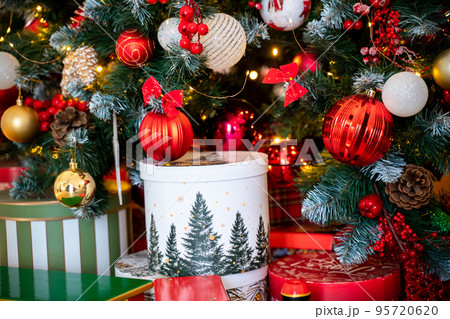 Christmas presents under the Christmas tree. New Year's and Christmas. Wrapped Gift. Beautiful packaging. Ribbon and bow on the packaging. Christmas presents under the Christmas tree. New Year's and Christmas. Wrapped Gift. Beautiful packaging. Ribbon and bow on the packaging. 95720620