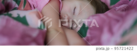 Little girl sleeping peacefully in pink bed at home Little girl sleeping peacefully in pink bed at home 95721422