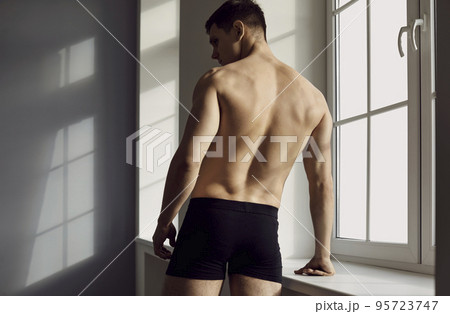 Young man in black underwear, with a beautiful, athletic body posing in the studio Young man in black underwear, with a beautiful, athletic body posing in the studio 95723747