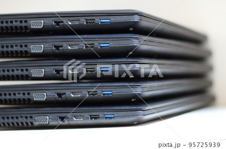 Input and connection sockets on side of laptops folded stack Input and connection sockets on side of laptops folded stack 95725939