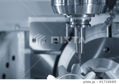 The 5-axis CNC milling machine  cutting the metal gear part. 95726689